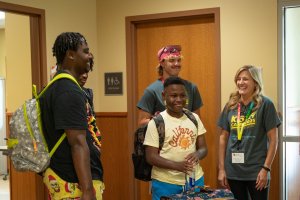 Campers gathering with staff in the camp office