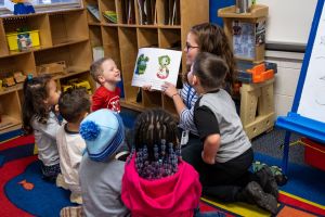 teacher reading regie book